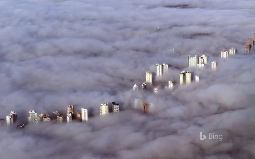 Aerial view of buildings enveloped by a thick fog in Curitiba, Brazil